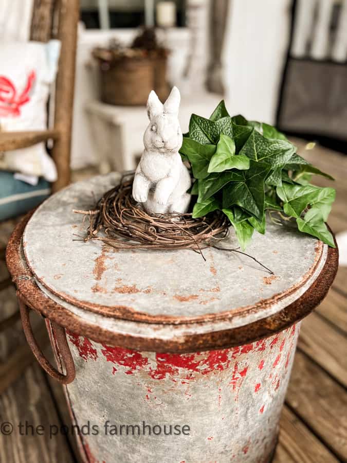 Concrete bunny for Easter Decorating with grapevine wreath and ivy greenery.  Easter Decorating.