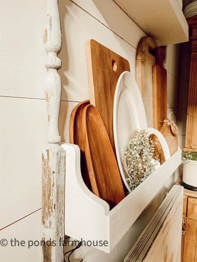 Easy DIY Plate Rack filled with breadboards, wooden bowls and ironstone for Farmhouse Style Kitchen Decor.