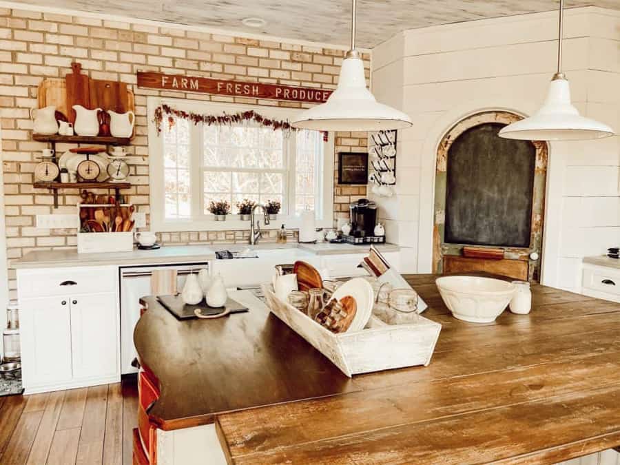 Modern Farmhouse Kitchen with a DIY Farmhouse Style Island.  Unique Pantry Door and Open shelves on brick wall.