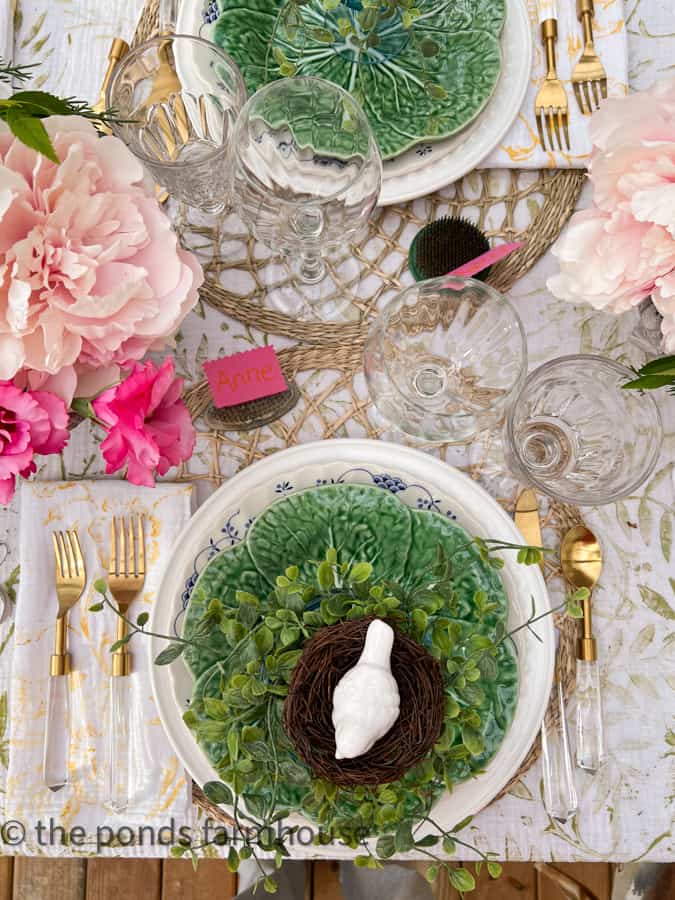 Tablescape with white bird on birds nest at each place setting with gold and acrylic cutlery.  Farmhouse Style