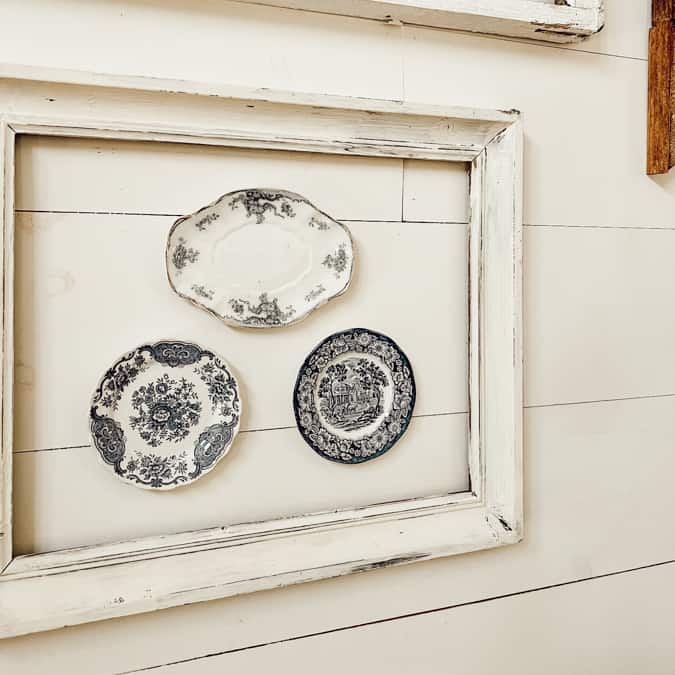 Upcycle Vintage PIcture frames by adding antique dishes and other collectibles to the empty frame.  