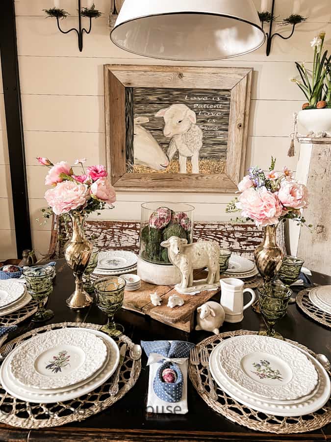 Affordable Decorated Easter Tables with lamb painting and lamb centerpiece.  Peonies and floral dinner plates.