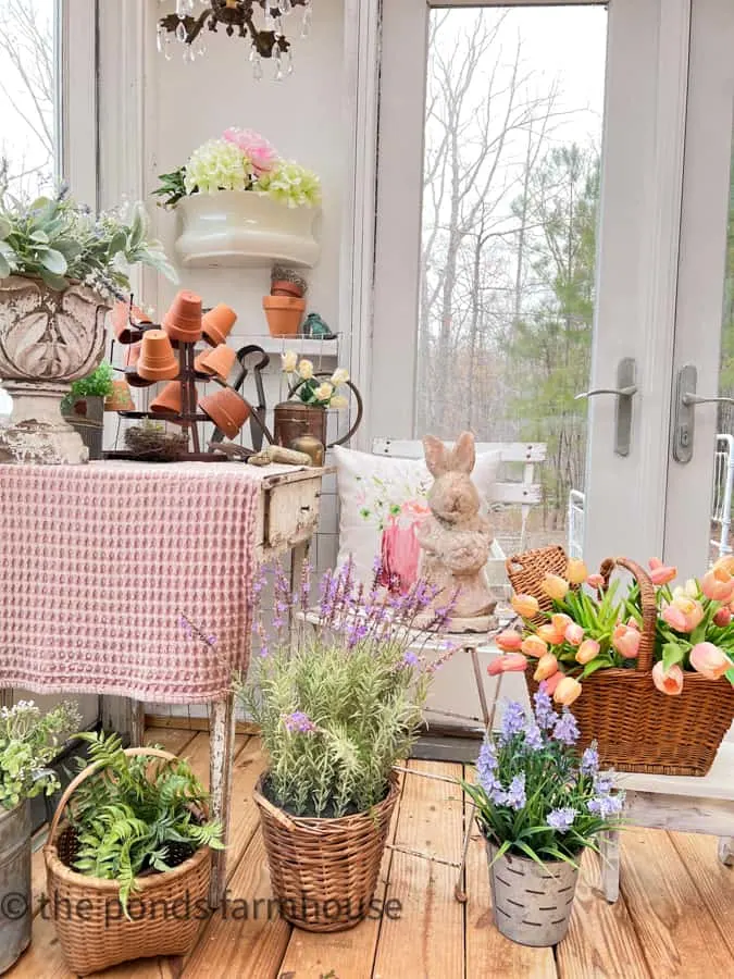 She Shed filled with Spring Vignette including faux flowers and chippy desk with pink table cloth.