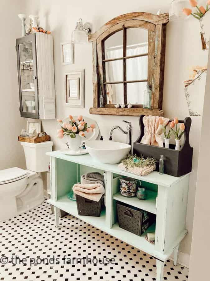 Spring Bathroom Refresh Tips - turquoise and pink mix with vintage tile black and white floors.  