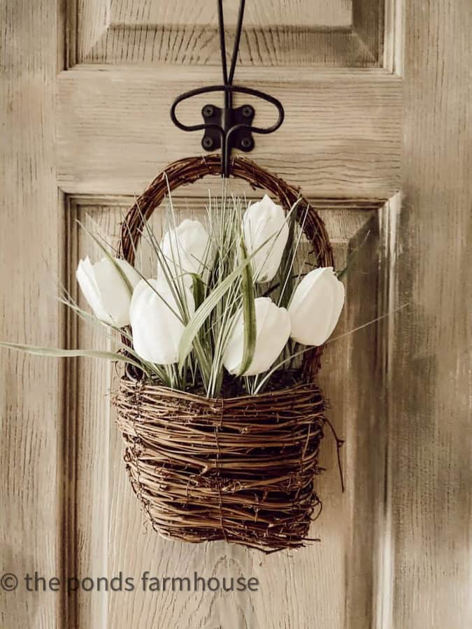 Basket of tulips hanging on the vintage bathroom door.