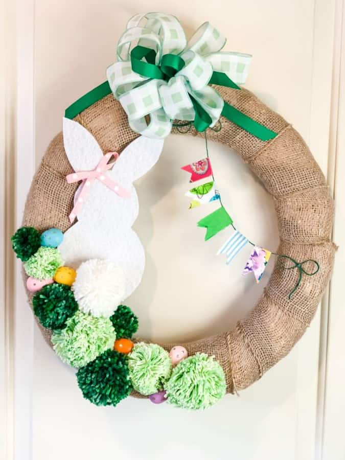 A cute bunny and pom poms decorate a DIY Easter Wreath for spring.  Great Easter home decor ideas.