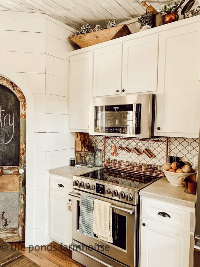 Decorate above kitchen cabinets and around stove with Country Chic style in a DIY copper spice rack and vintage spice bottle.