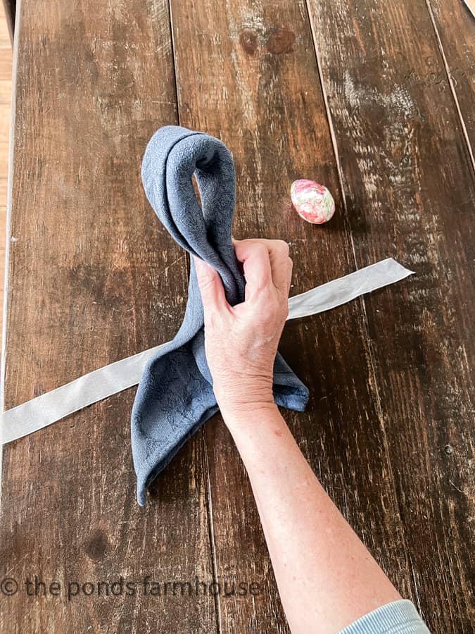 Make a loop for Bunny Ears Folded Napkin for Easter Tablescapes.