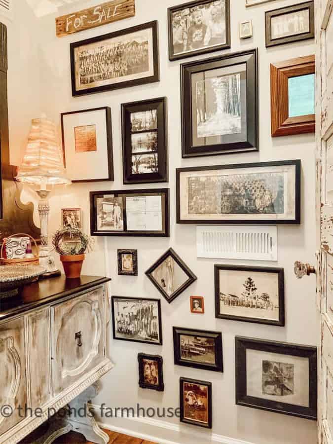 Gallery wall with thrift store frames repurposed to match for powder room gallery wall.  