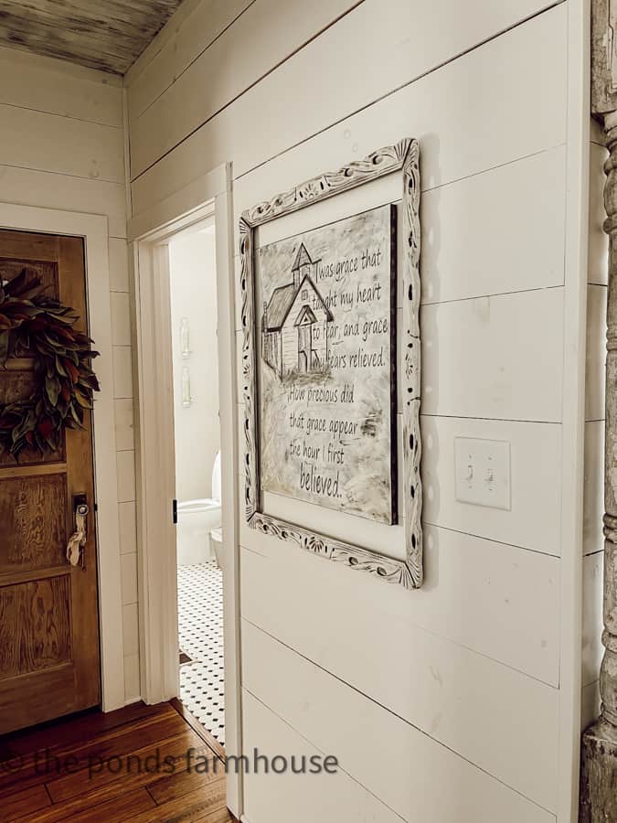 Add a smaller canvas painting to a larger antique picture frame for more impact on a shiplap wall.  