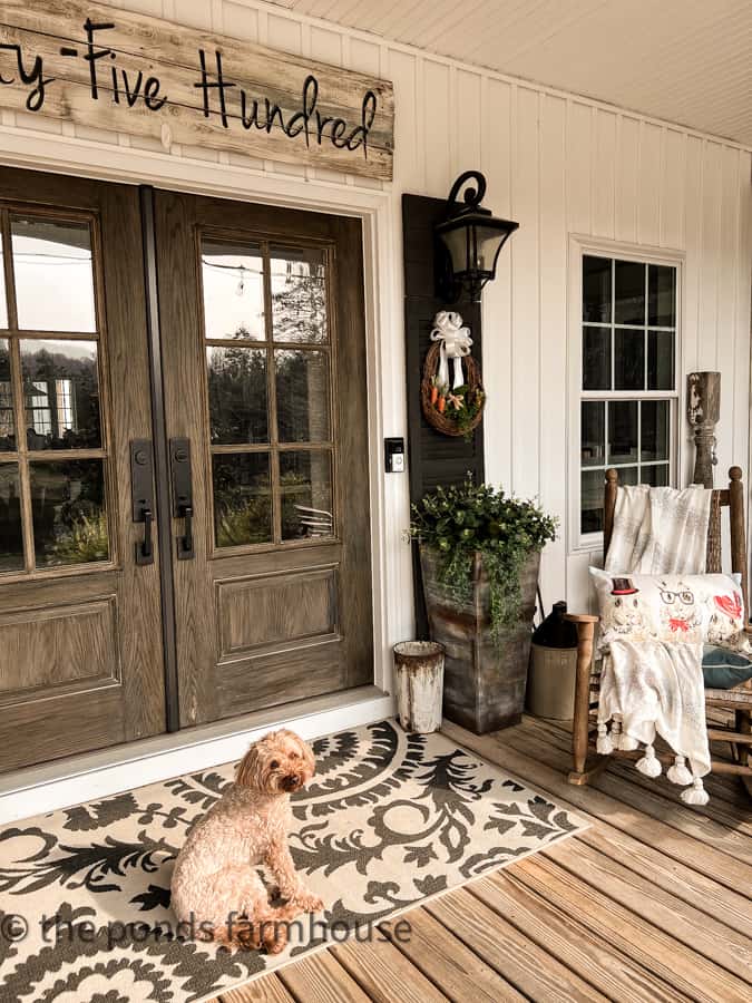 Rudy, Mini-Goldendoodle greets you on the front porch for Spring.  DiY Easter Wreaths for Spring Decorating.