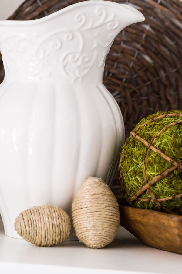 Easy DIY Project with jute twine covered Easter Eggs.  Mixed with a wooden tray and moss ball, ironstone pitcher for a Spring vignette.