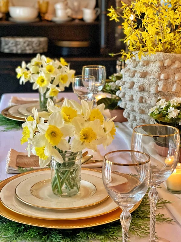 Bring Spring flowers inside the house with daffodil bouquets on each dinner plate for a Spring tablescape.