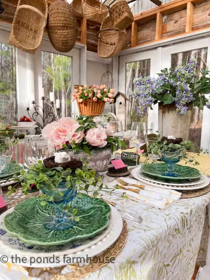 Farmhouse Style  Tablescape with garden-inspired tableware and lilacs in a sap bucket and tulips in a basket