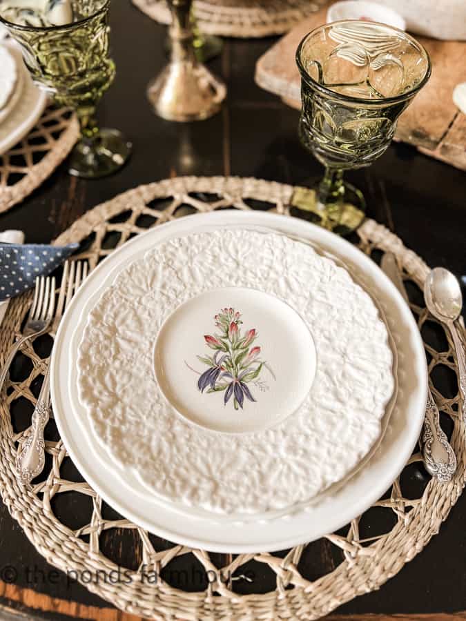 Thrift Store floral dinner plates with woven placemats and vintage silverware.  