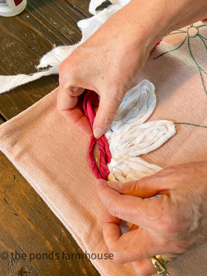 Use pink fabric to make flower centers on pillow covers.