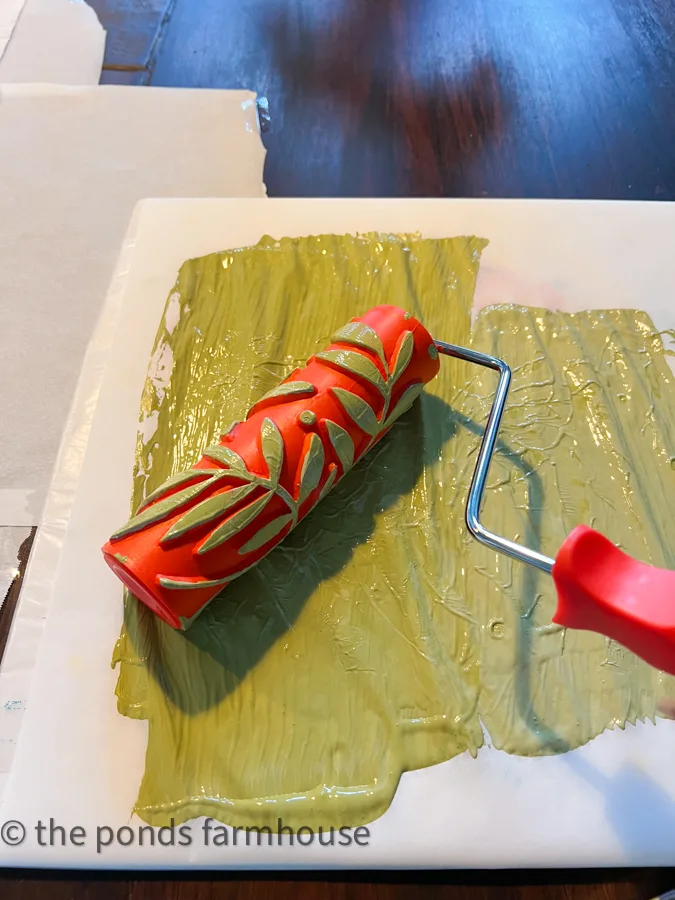 Use decorative leaf roller with green paint for a custom tablecloth.  Farmhouse Style Tableware.