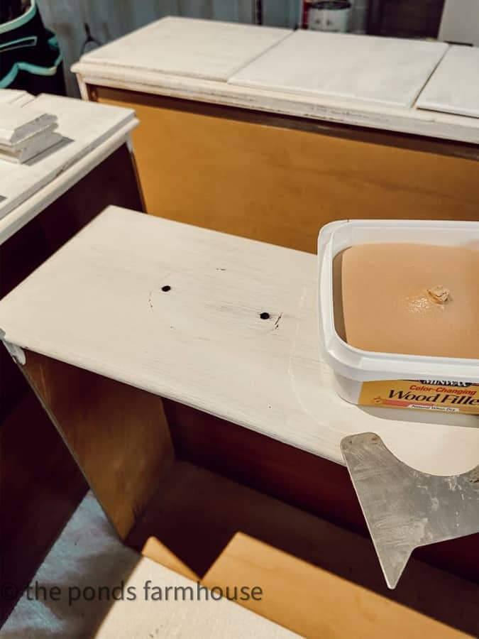 Fill the hardware holes with wood filler on the drawer fronts. 