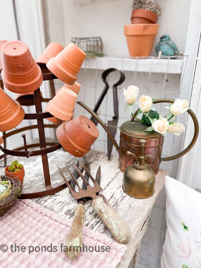 She Shed Interior Ideas with terra cotta pots and vintage garden tools.