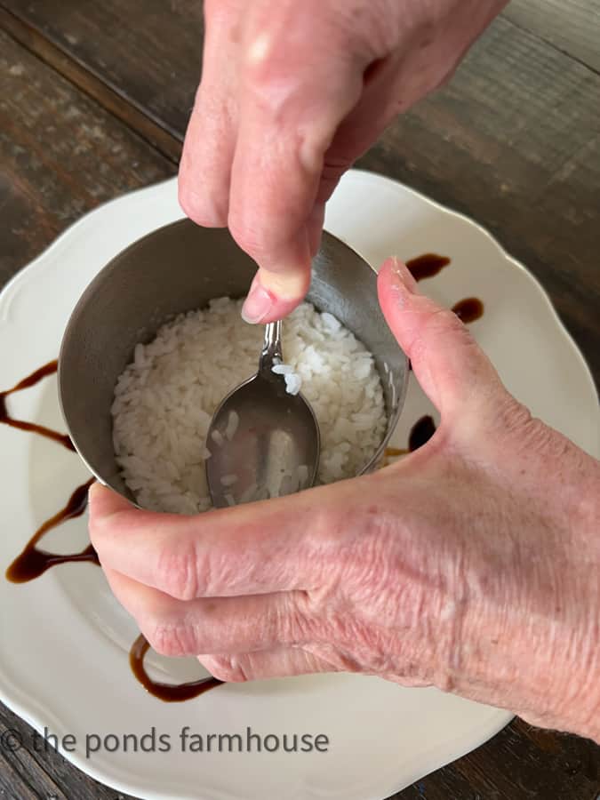 Sticky Rice in bottom of metal mold is first layer of the poke tuna stack