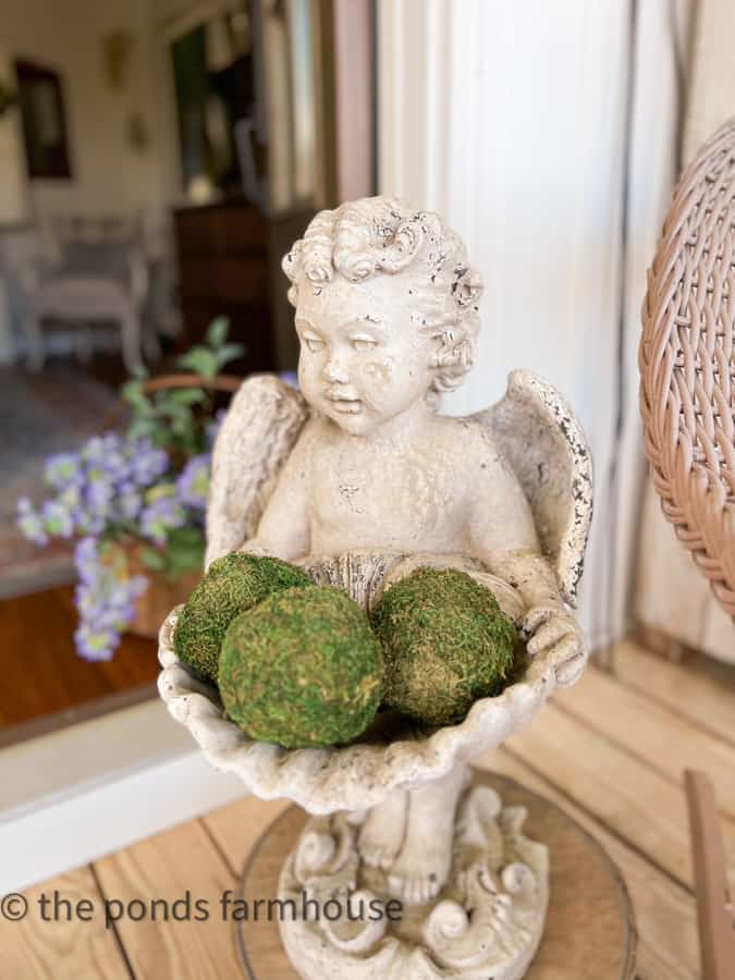 Old concrete angel holds moss balls in the clam shell planter. A favorite Vintage Garden Statuary