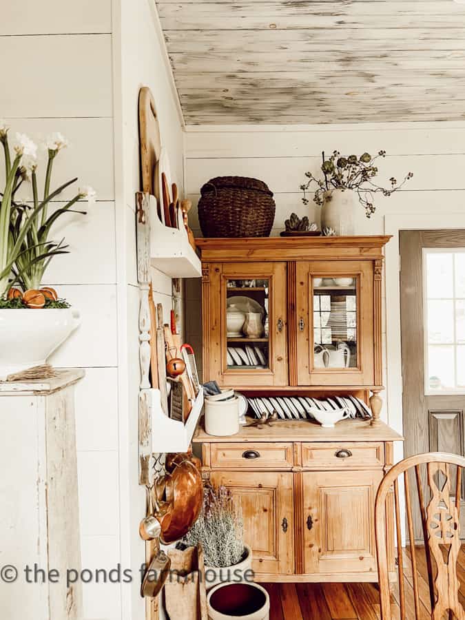 Antique Furniture - Pine Hutch with vintage basket & crocks on top, DIY plate rack with copper, and breadboards.  