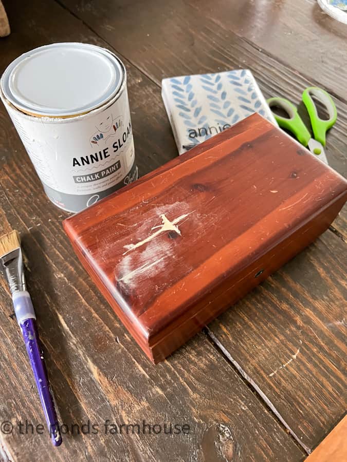 Wooden cedar box with damaged top repaired with wood filler.