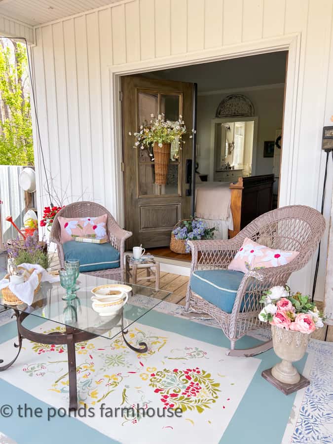 Sitting on a front porch with DIY painted rug and DIY scrap fabric recycled pillows.  