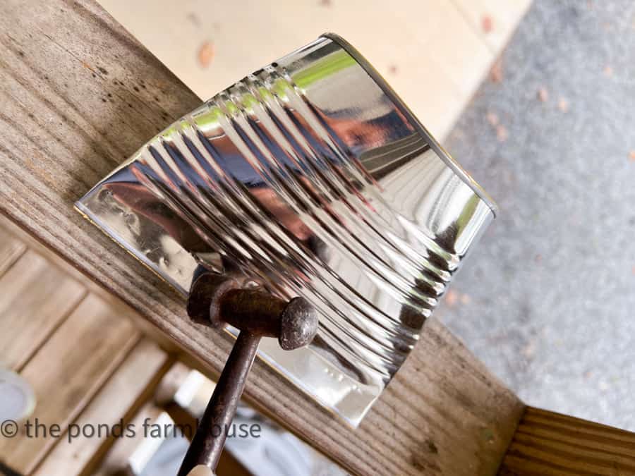 Use Hammer to seal the bottom of tin cans for flower pockts.