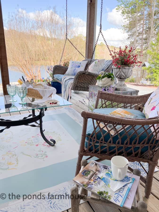 Porch swing and wicker chairs for farmhouse decorating.