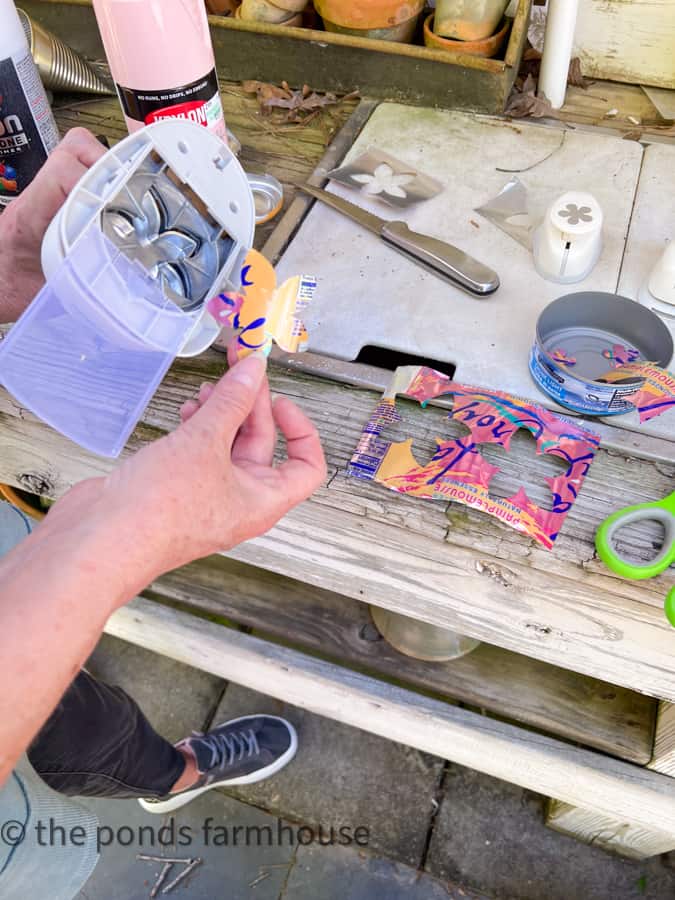 Create unique flowers from aluminum cans for DIY recycled plant pots. 