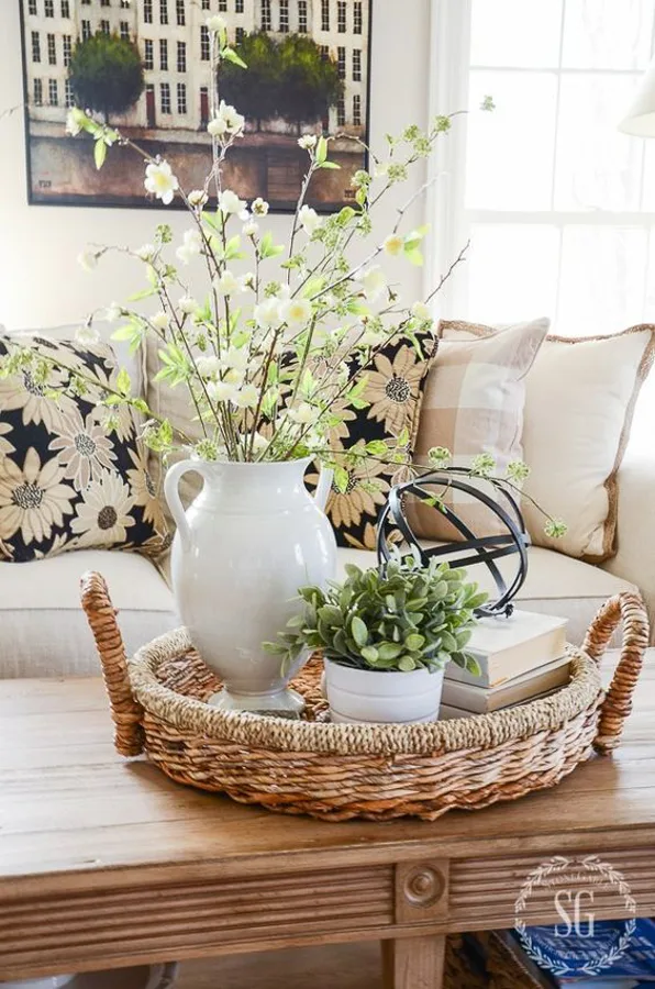 woven tray is foundation for coffee table decorating centerpiece