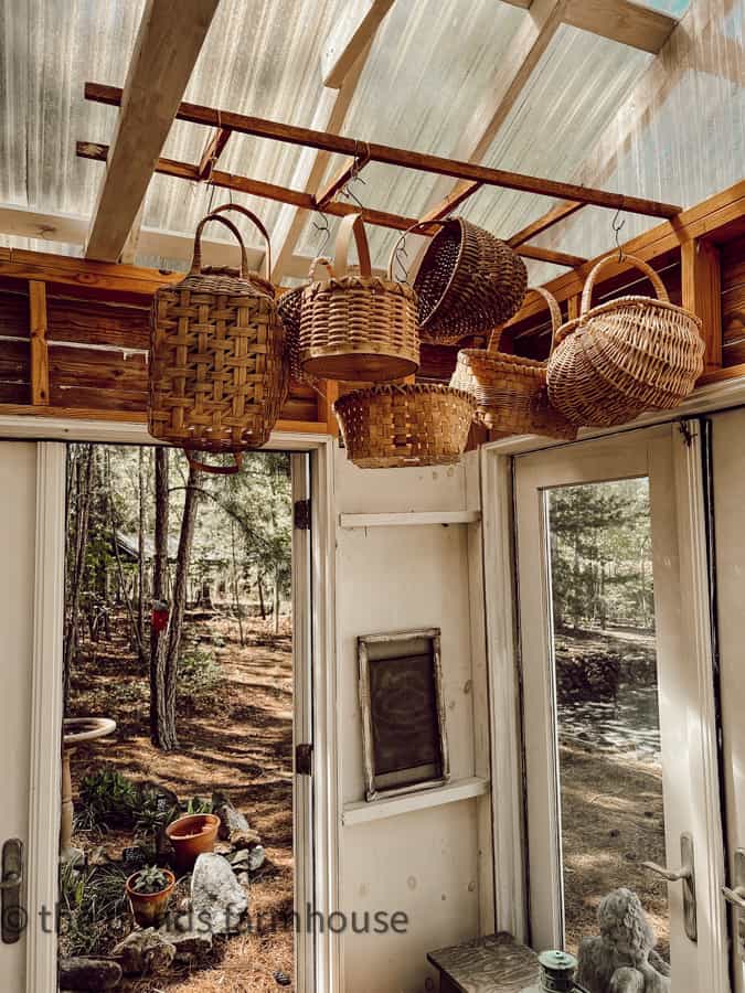 Tobacco Stick Ladder holds more vintage & thrifted handmade baskets for a farmhouse style greenhouse.