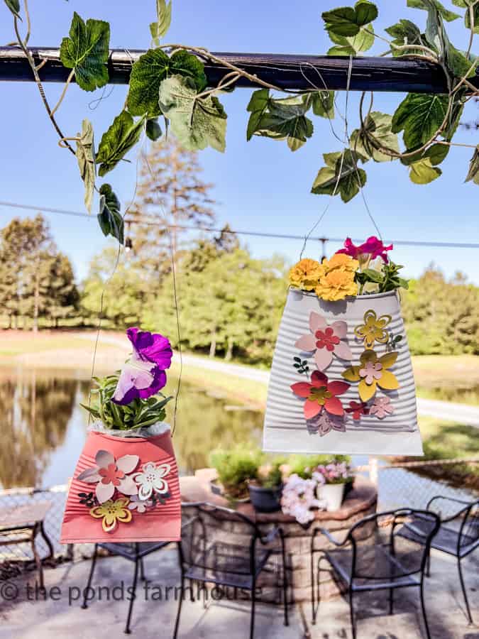 Add fresh flowers to the DIY Plant Pots made from recycled materials.  Hang from decorative table stand.