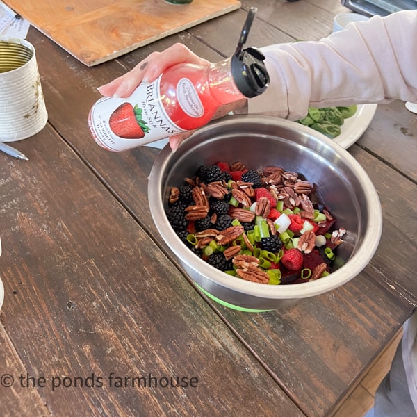 Toss beets, fruit and nuts with prepared salad dressing.  