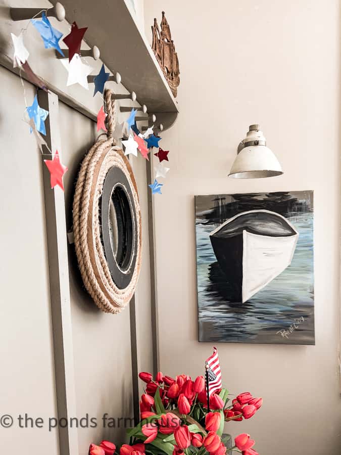 Nautical Mirror and boat painting with patriotic metal star garland.