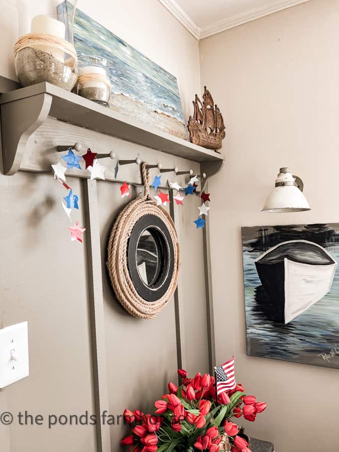 Accent Wall filled with metal star garland for 4th of July Decorating in a coastal cottage.