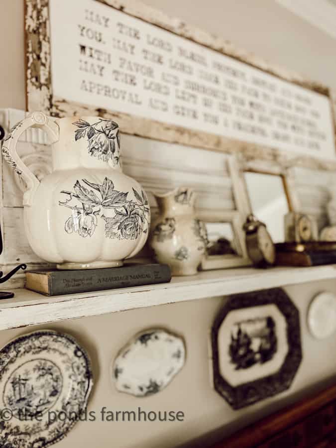 blue and white transferware pitchers decorate above the bedroom bed.