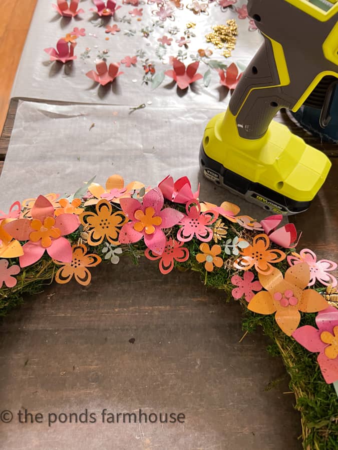 Make metal wreath from recycled aluminum cans.