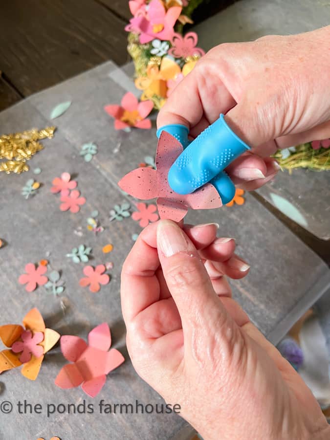 Bend metal flowers to shape before adding the Recycled Aluminum can metal wreath.