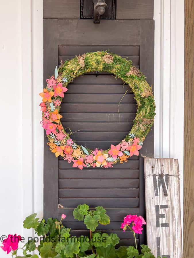 Add DIY Metal Wreath made from Aluminum can flowers to shutters beside the front doors.  