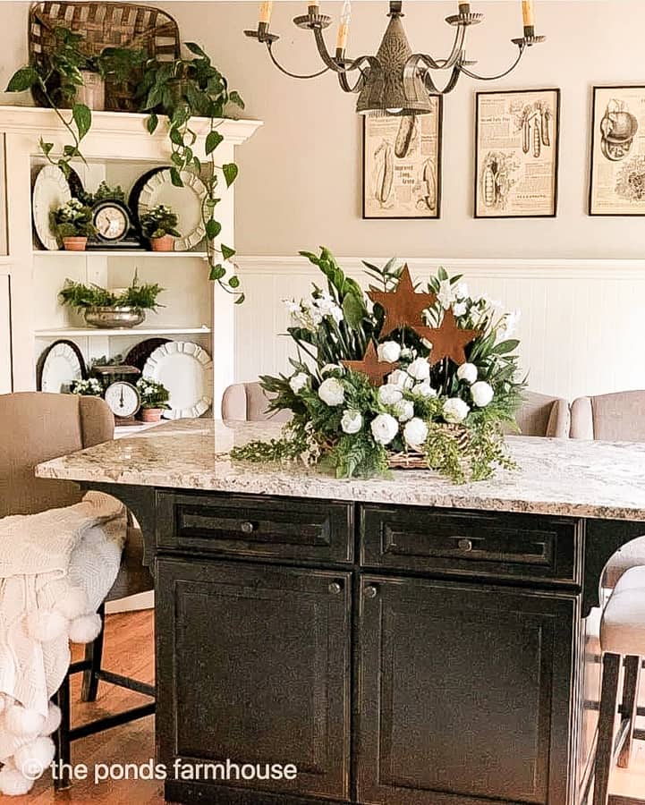 Rusty metal stars add patriotic decor to a white flower arrangement