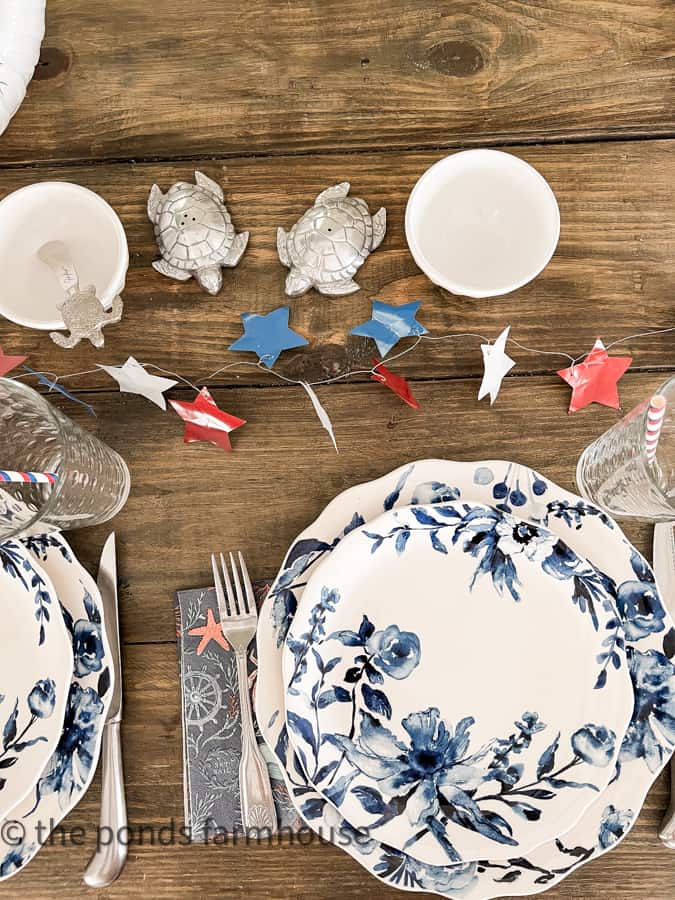 Metal Star Garland with blue and white dishes for patriotic tablescape