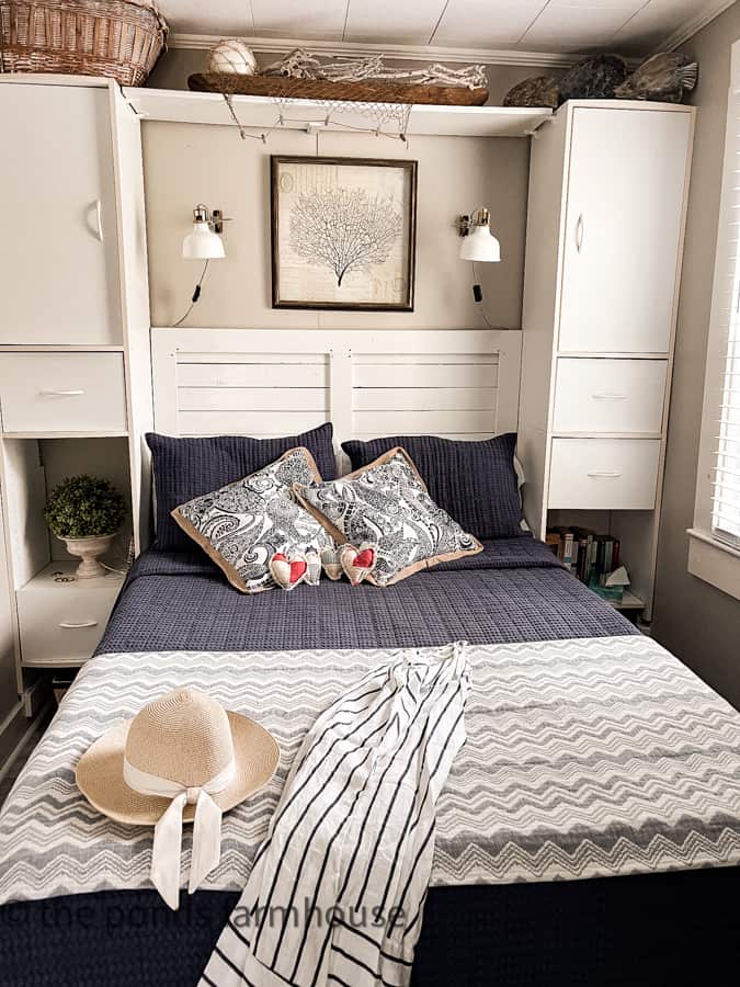 Beach Cottage Bedroom with navy and white bedding plus heart pillow for Patriotic 4th of July decor.