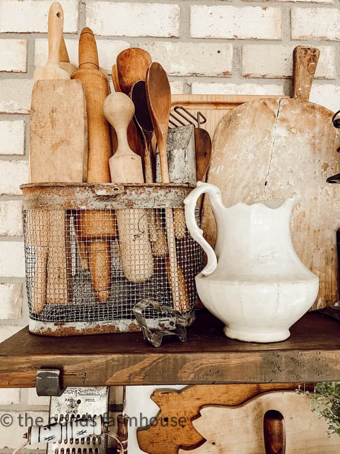 antique breadboard on open shelving in modern farmhouse kitchen add vintage charm with country chic style.