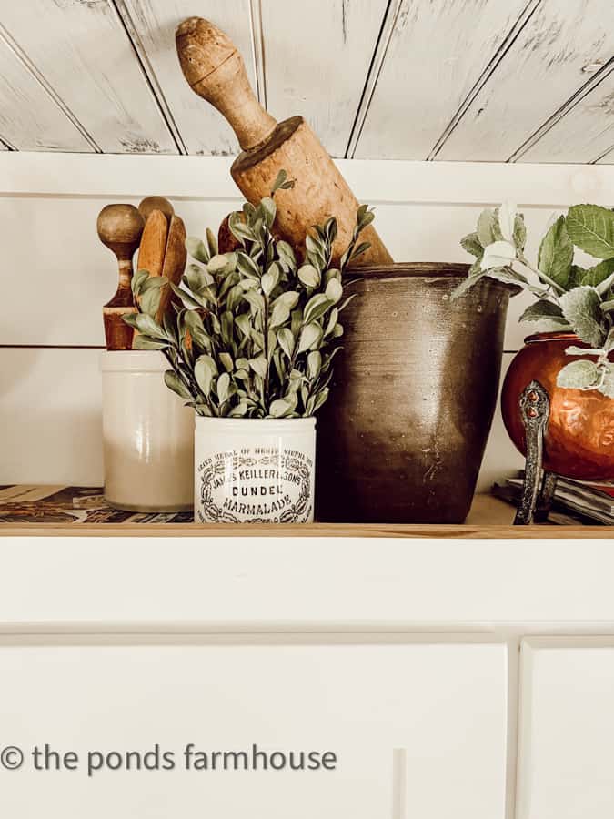 Add vintage rolling pins to above kitchen cabinets to style with vintage kitchen decor.