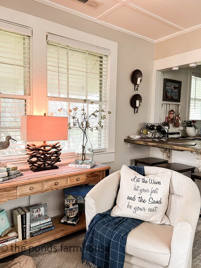 Coastal Cottage with patriotic decor.  beach pillow with cub chair and blue throw blanket