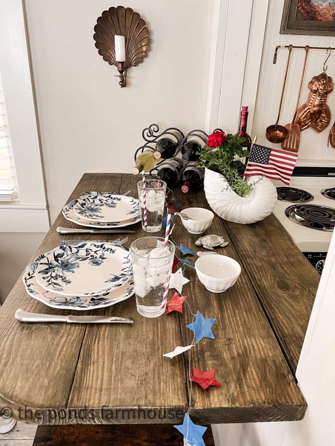 Eat in bar set with blue and white dishes for patriotic tablescape for 4th of July decorating.
