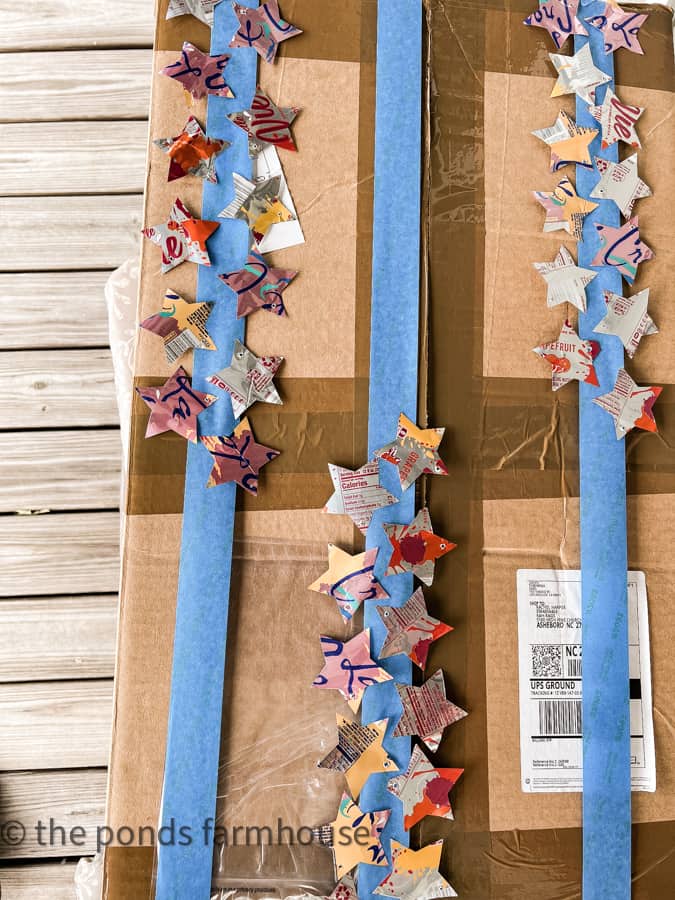 Use painters tape to attach aluminum stars to paint them.