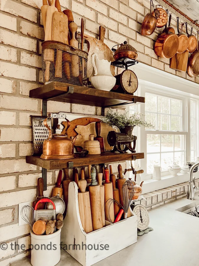 open shelving with vintage farmhouse decor in a industrial farmhouse style kitchen.